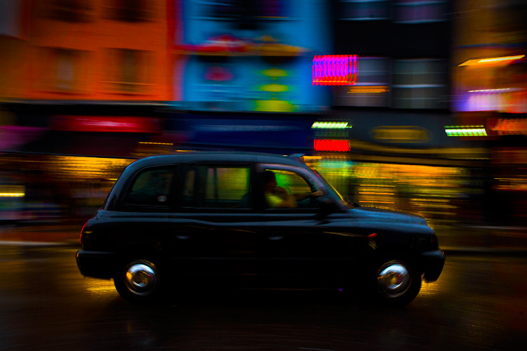 Black Cab in the Gloom of late Afternoon : Camden High Street : London UK