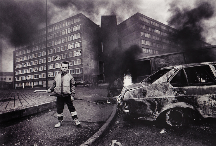 The Troubles : Child with Burning Cars Divis Flats : Belfast : Northern Ireland